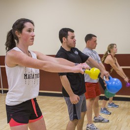 Student doing kettle ball exercises at the  Plex